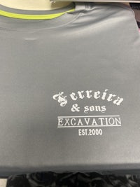 a grey t - shirt with a logo on it