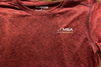 a red t - shirt with the word mdba on it