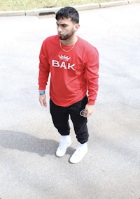 a man wearing a red bak sweatshirt