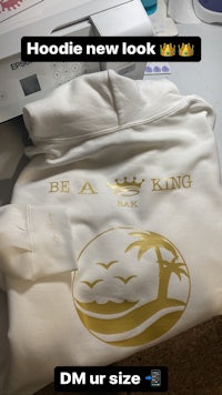 a white hoodie with the word be king on it