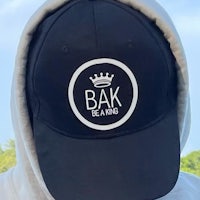 a man wearing a hoodie with the word bak on it